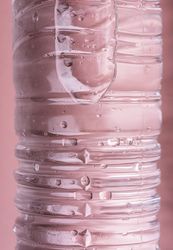 Water bottle on pink background close-up