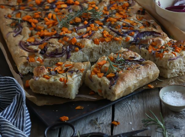 Pieces of fresh focaccia on wooden table