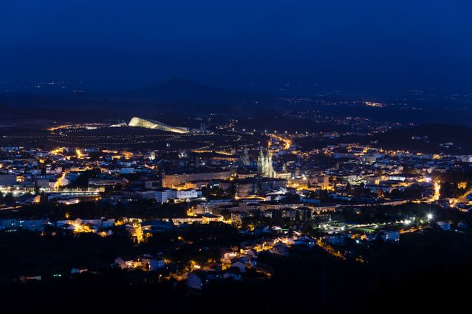 Scenic night cityscape with illuminated buildings and streets