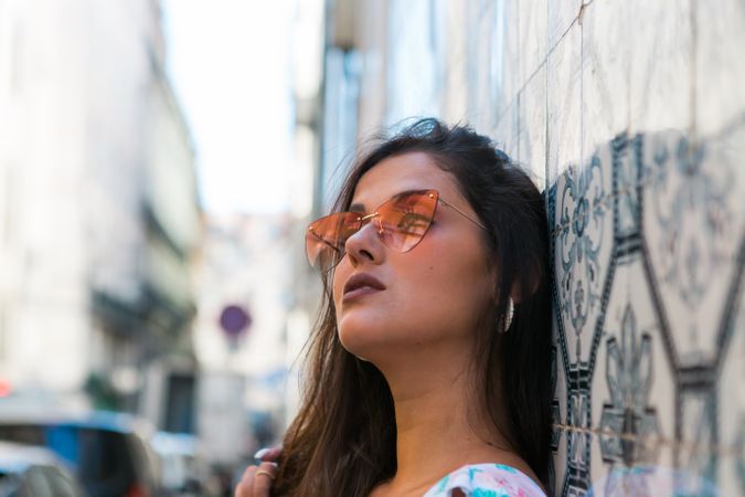 Woman in sunglasses standing on city street