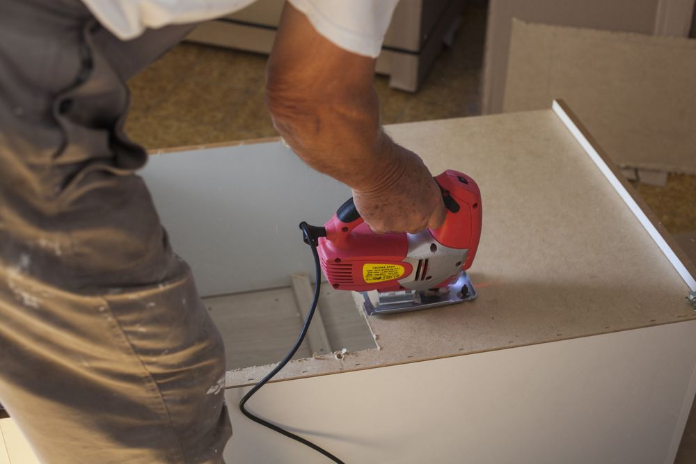 Cropped image of a carpenter using a nail gun