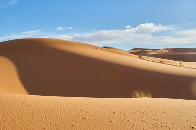 Sand dunes and blue sky with sun