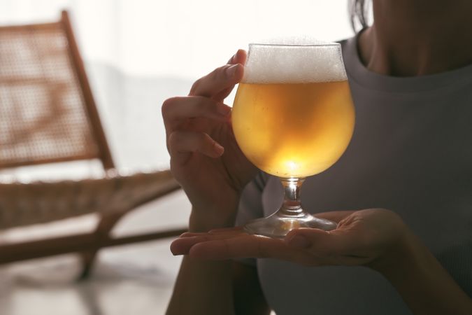 Anonymous sportswoman with glass of beer