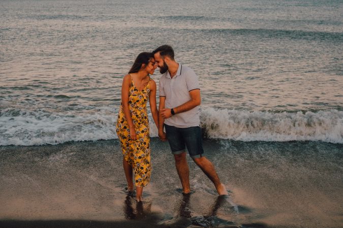 Loving couple embracing happily on sandy beach