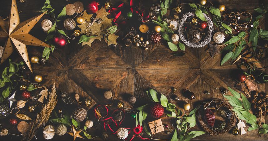 Holiday decorations of stars, baubles, leaves, and ribbon, with copy space