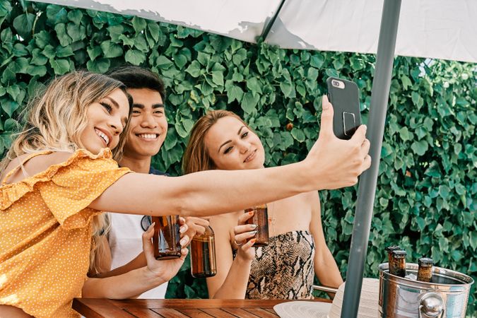 a group of young people making a selfie with last generation mobile phone