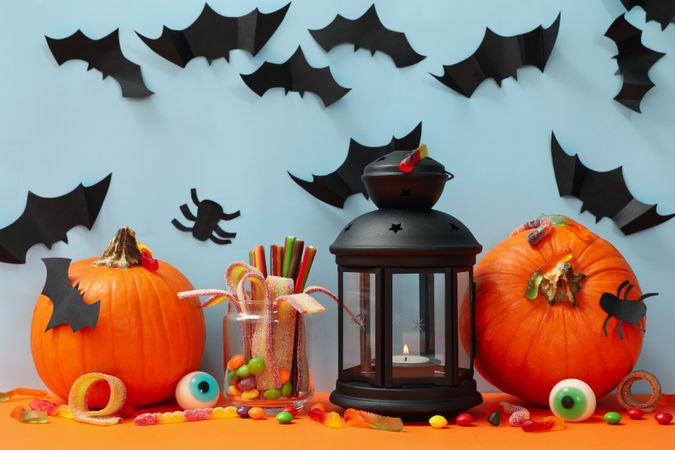Pumpkins and halloween accessories on blue background