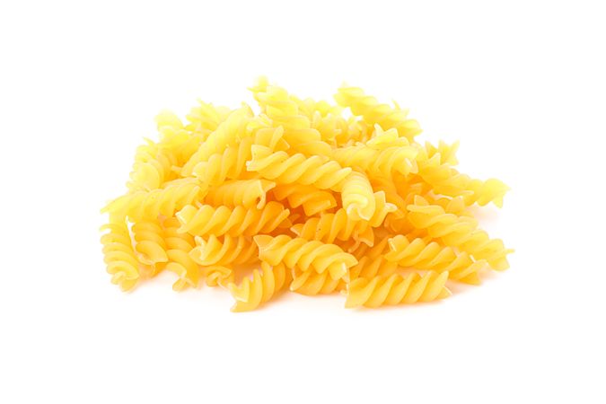 Pasta isolated on light background, closeup. Dry uncooked whole pasta