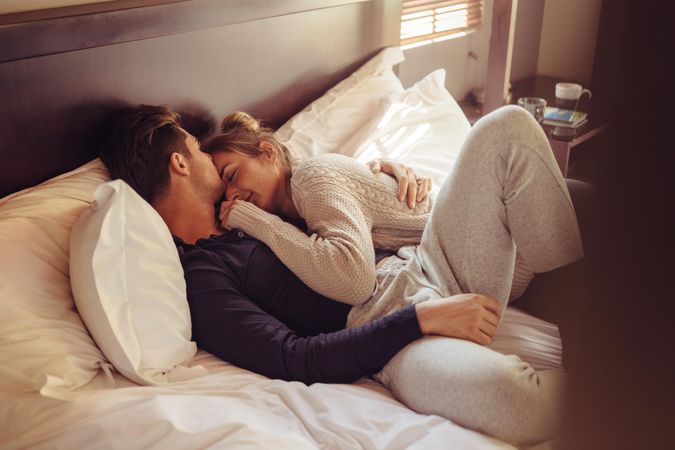Loving young couple sleeping together in bed