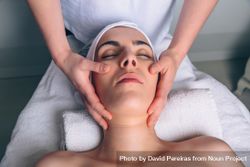 Woman receiving a relaxing facial treatment 5oDMqz