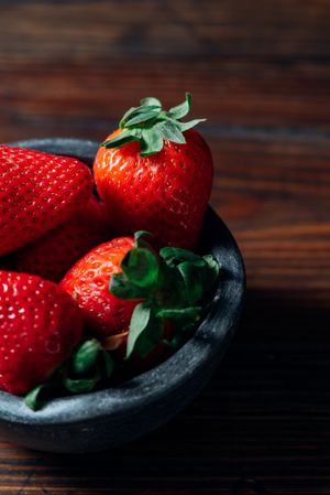 Fresh ripe strawberries in concrete bowl