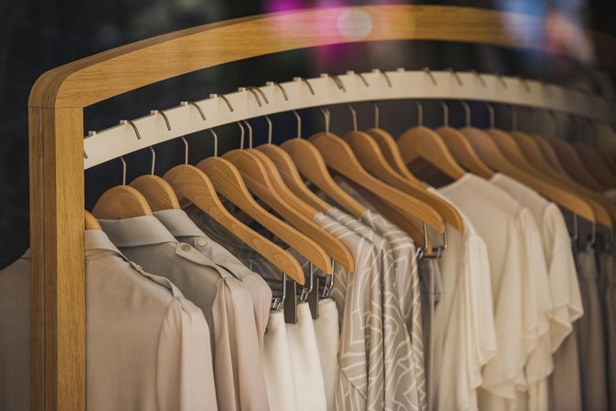 Clothes rack of beige outwear in fashion store