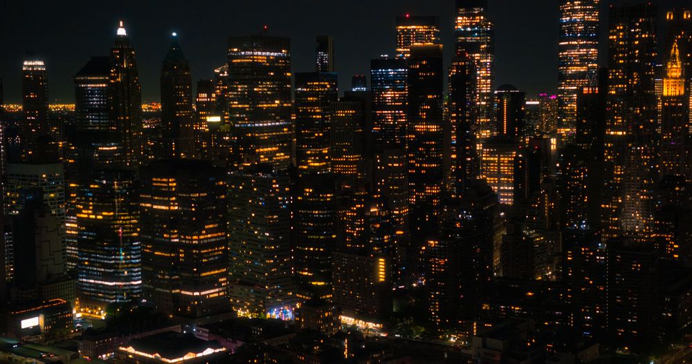 Helicopter Tourist Tour Around New York City at Night. Aerial View with a Picturesque Illuminated Office Buildings, Scenic View with Manhattan Skyscrapers Panorama