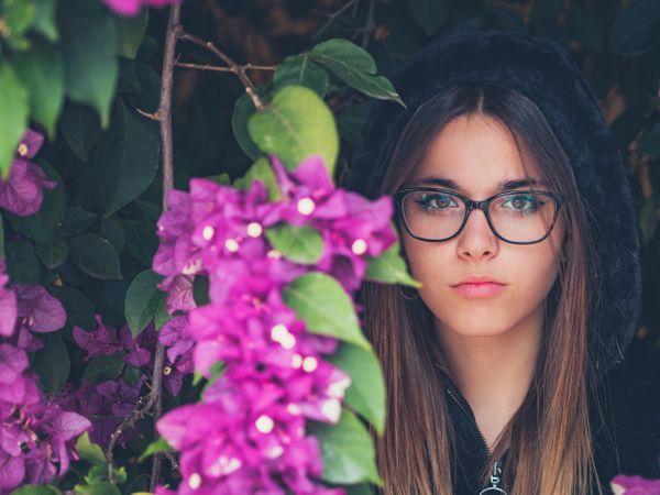 Woman on background of stunning violet flowers