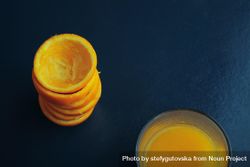 Stack of squeezed tangerines and a glass of juice, landscape 5anzv4