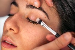 Close-up of a woman having her eyes made up