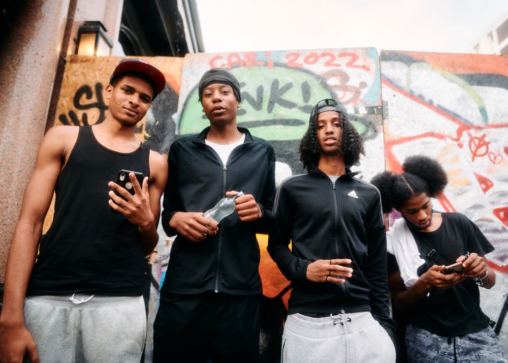 London, England, United Kingdom - August 28, 2022: Group of Black male friends standing in London st
