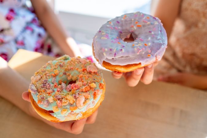 Women enjoying decorated donuts