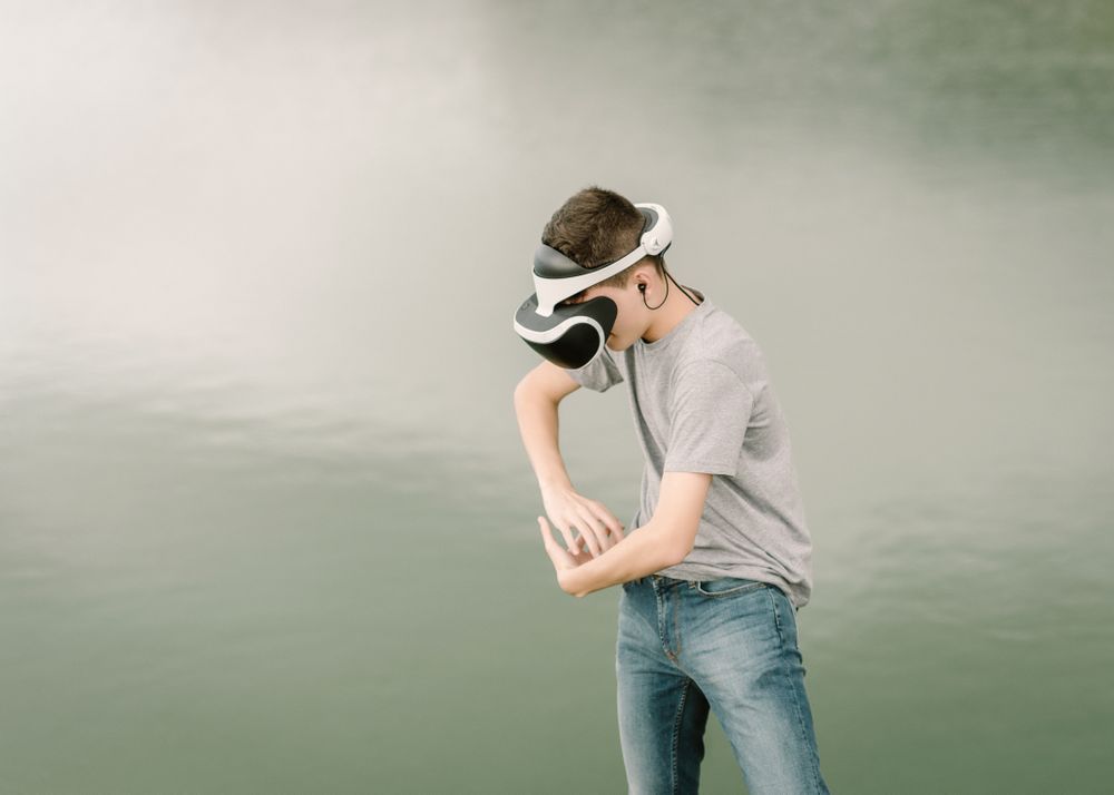 Young teenager with virtual reality glasses outdoors