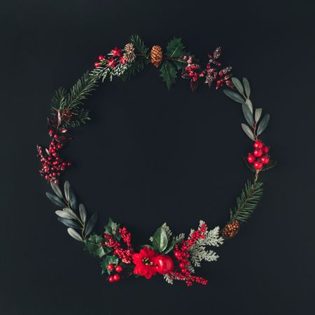 Flat lay of holiday wreath on dark background