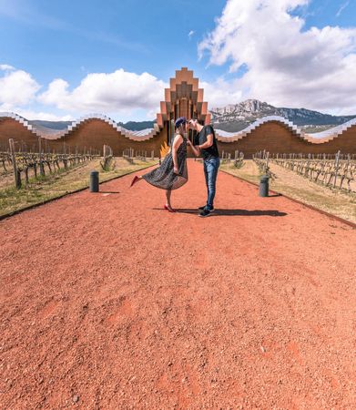 Couple walking along breathtaking geometric architectural building