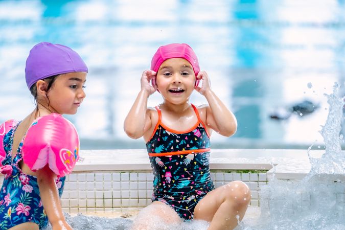 girls with water wings in swimming pool
