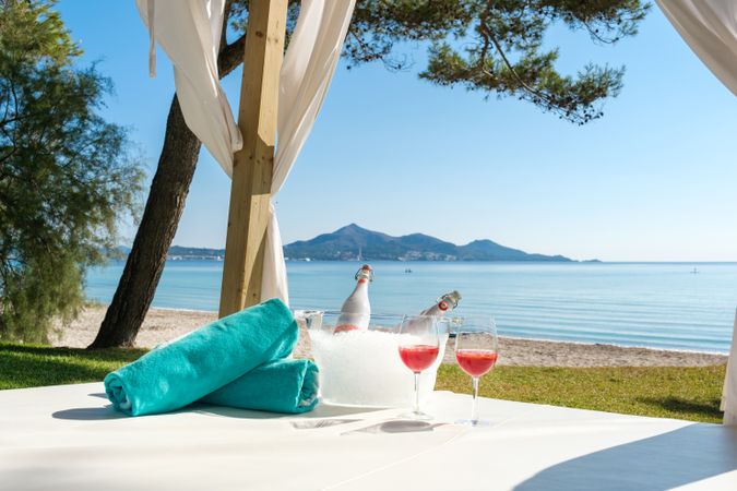Canopy bed with wine on seashore