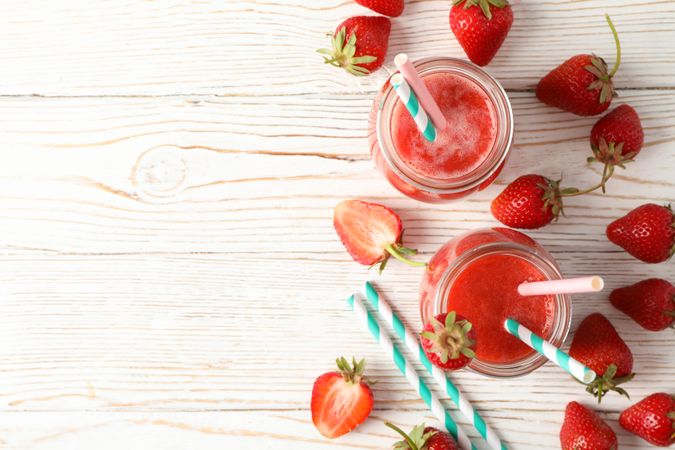 Composition with strawberry cocktails on wooden table. Summer berry