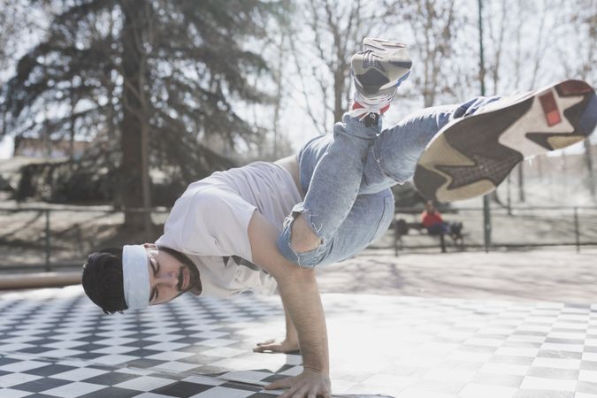 Man dancing break dance in park