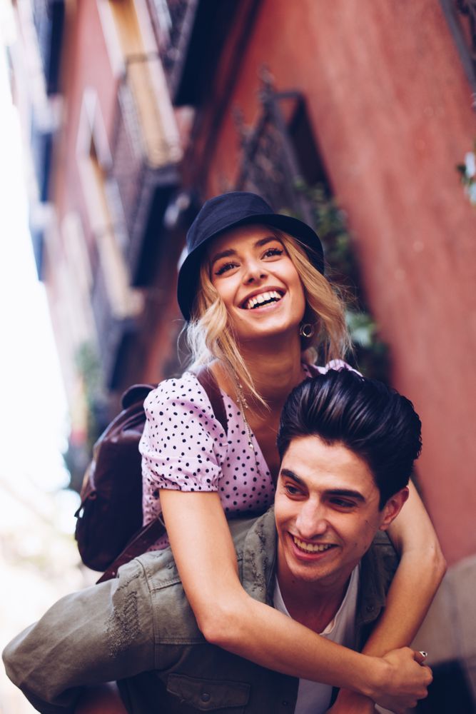 Happy couple having fun while walking in town