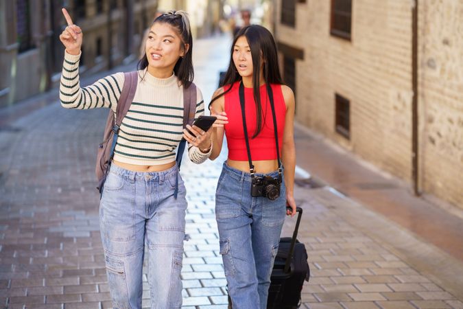 Two women sightseeing along Spanish street