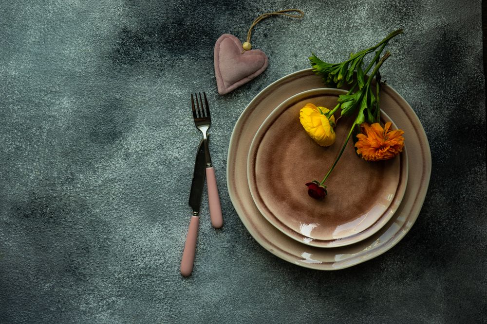 Elegant table setting with heart decoration and buttercup flowers