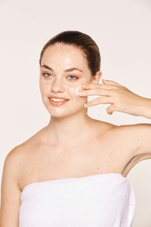 Amiable female taking care of face