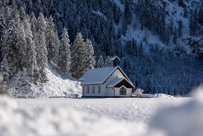 Winter landscape with a church in deep snow nature in the Bavarian Alps, Germany