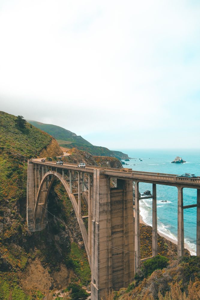 Cars on Bixby Creek bridge near sea in Big Sur,California,United States