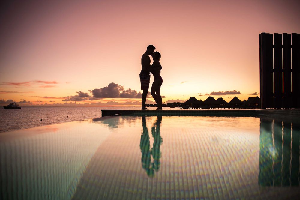 Silhouette of man and woman kissing each other during sunset