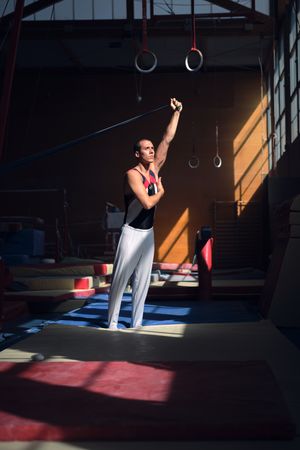 Young sports gymnast stretching with a rubber band in the gymnas