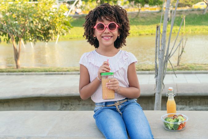 Girl having a healthy drink in the park