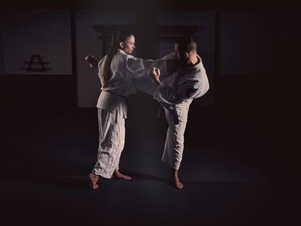 Man kicking woman during Krav Maga training