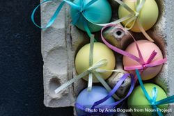 Top view of decorative pastel Easter eggs with ribbons 5aX3nd