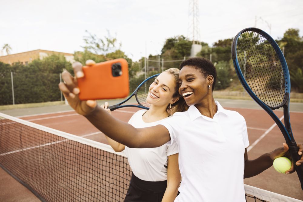 Portrait of two young women on a tennis court