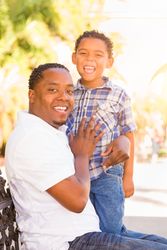 Portrait of Happy Son and Father Outdoors Together.