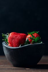 Fresh ripe strawberries in concrete bowl
