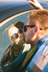 Young couple kissing through the glass