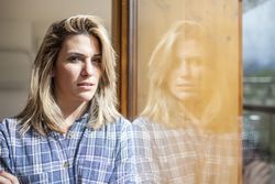 Woman at home looking at camera