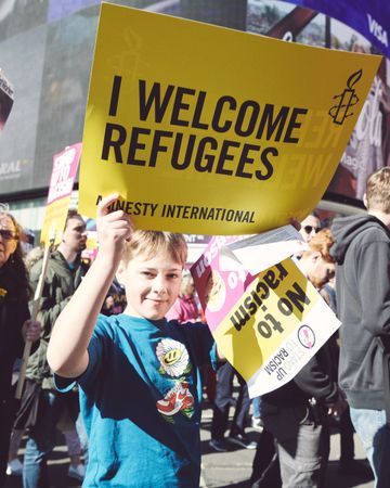 London, England, United Kingdom - March 19 2022: Boy with “I welcome refugees” sign
