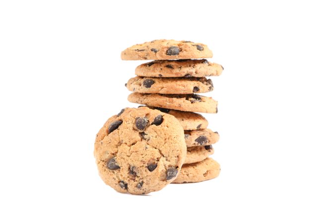 Stack of tasty chocolate chip cookies on white background