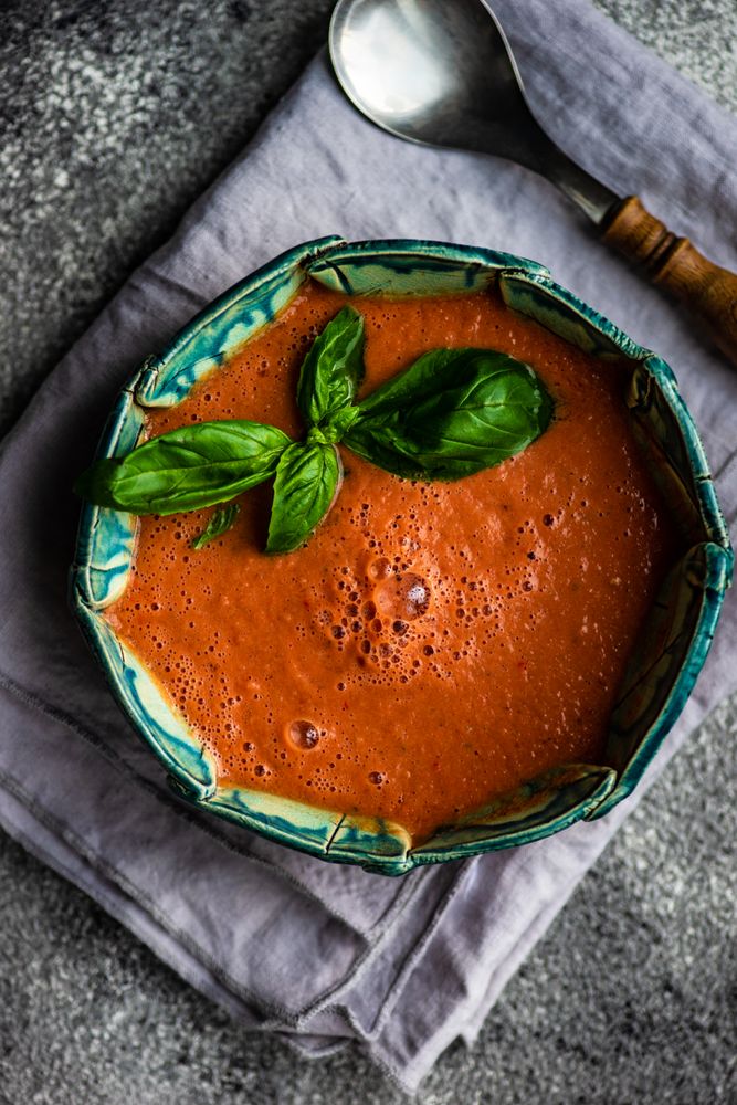 Top view of traditional Spanish tomato soup Gazpacho with basil