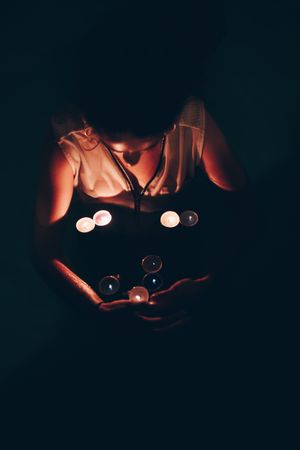 Woman swimming in pool with candles