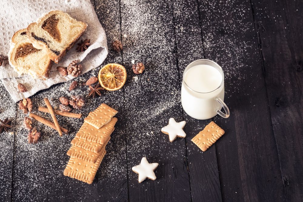 Sweets and roasted nuts on wooden table